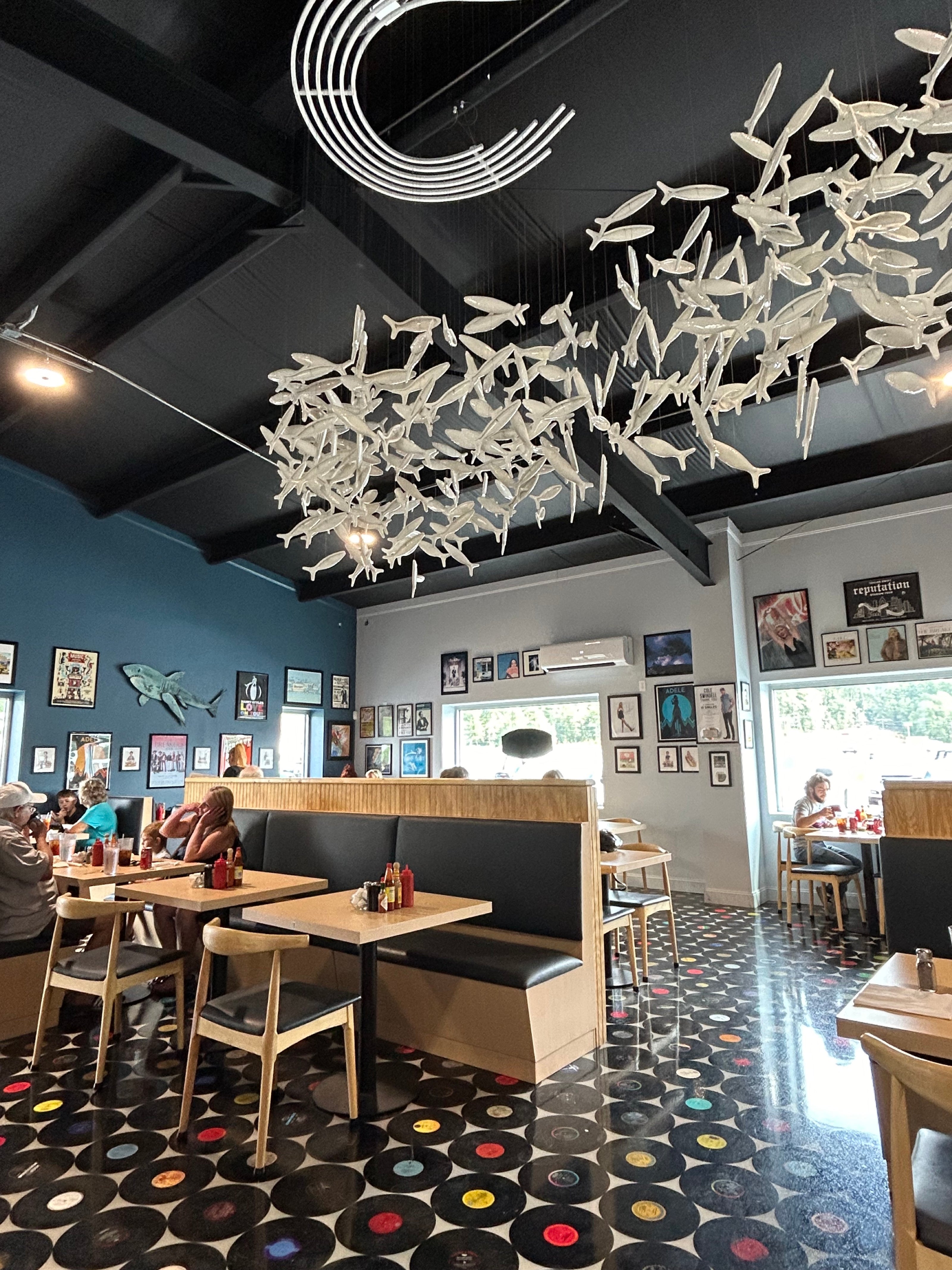 Interior of Patty’s diner with vinyl-record flooring, retro memorabilia, and booth seating.